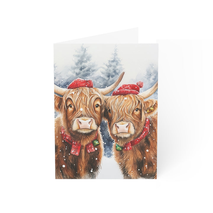 Highland Cow Christmas Card Cute Winter Holiday Greeting with Festive Red Hats & Bells Perfect for Farm Animal Lovers and Seasonal Cheer